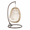 Chaise suspendue en rotin avec cadre métallique et coussin beige